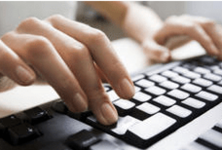 Hand on Computer Keyboard