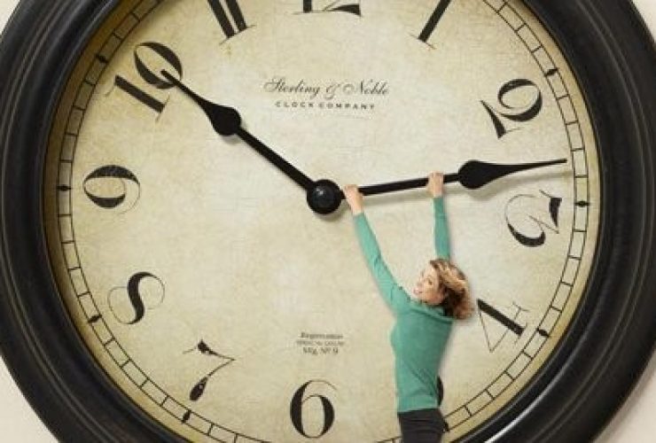 Woman hanging on clock hand